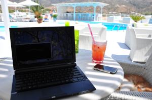 Laptop at pool by beach