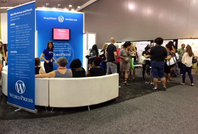 The WordPress.com booth hums with activity at BlogHer '14.