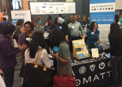 people gathered around the Automattic table at the career fair